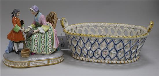 A Continental porcelain group and a faience basket